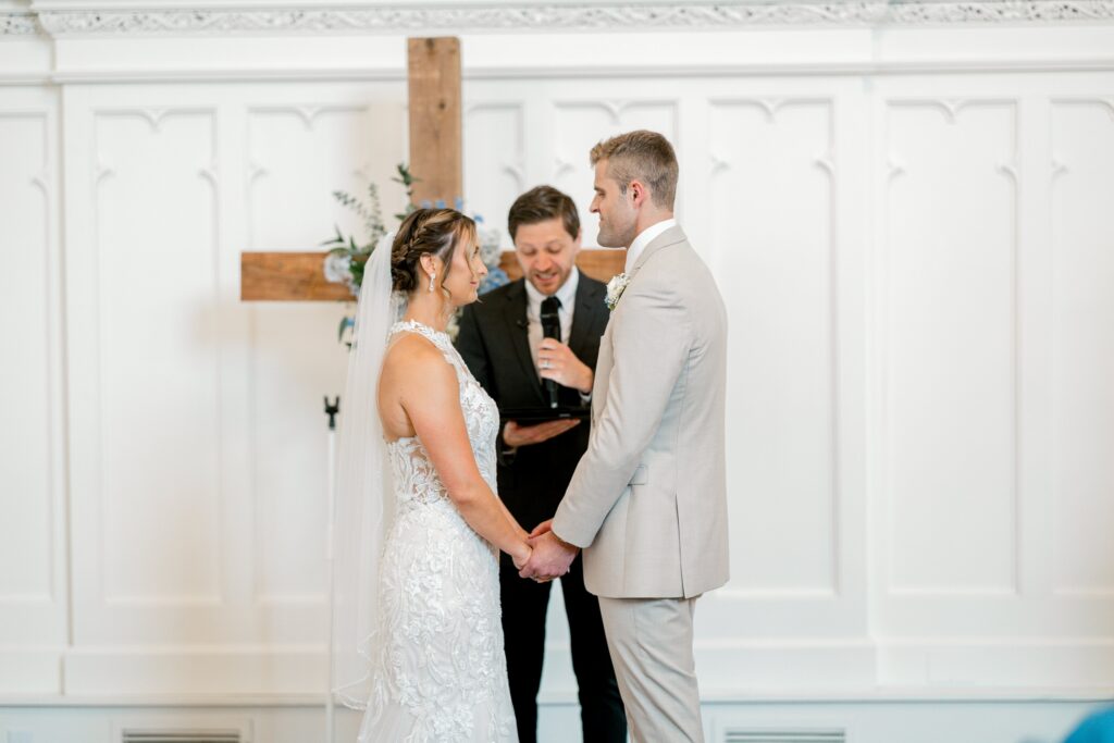 Bride and groom exchanging rings during their ceremony at The Broadway Avenue