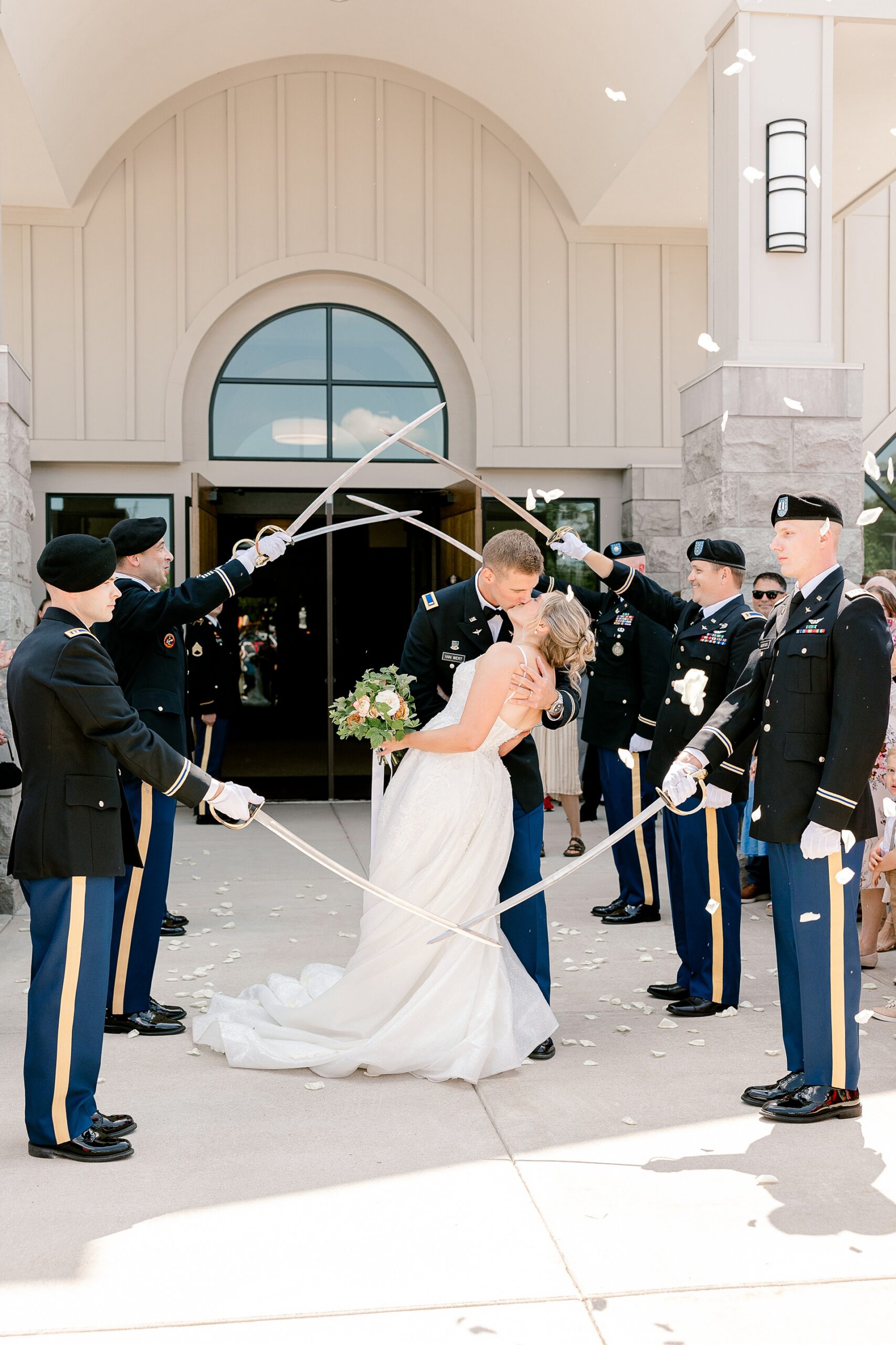 Bride and groom walking under a saber arch at their military wedding