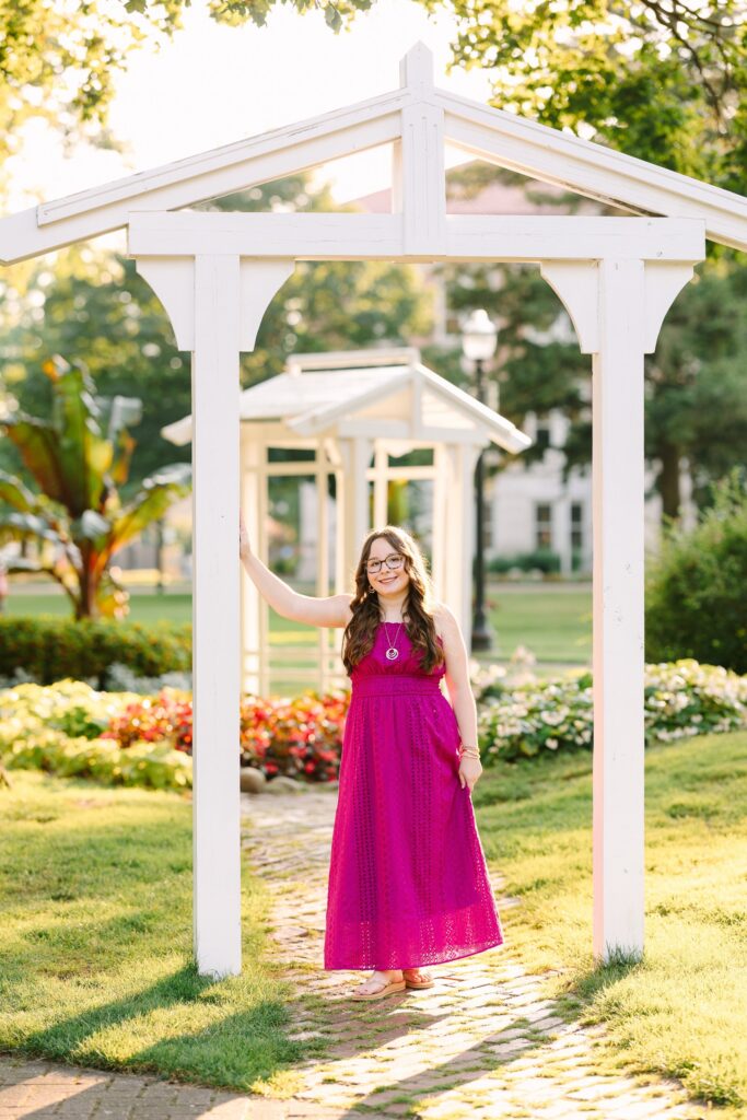 Senior portrait in front of a white gazebo in downtown Holland, Michigan