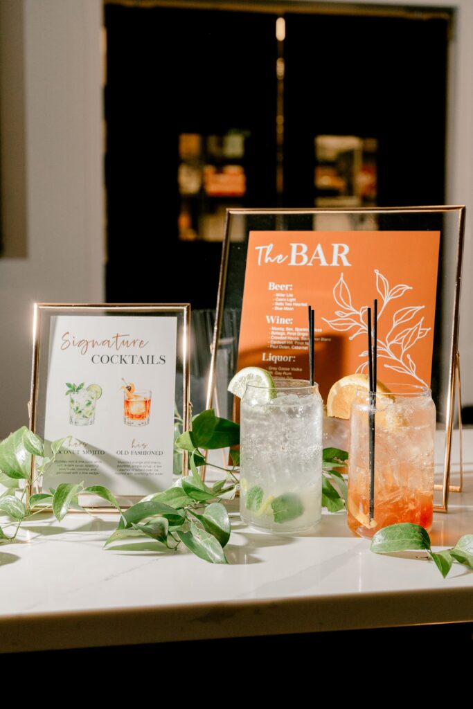 Signature cocktail and bar menu signs with drinks on the bar