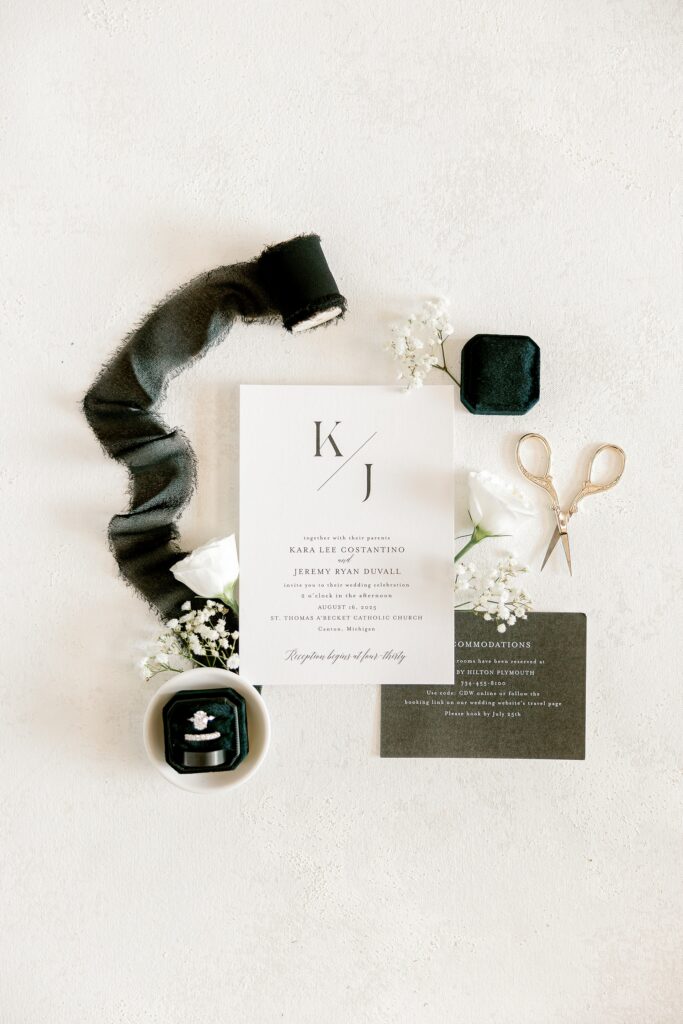 Wedding stationery flat lay with black velvet ribbon