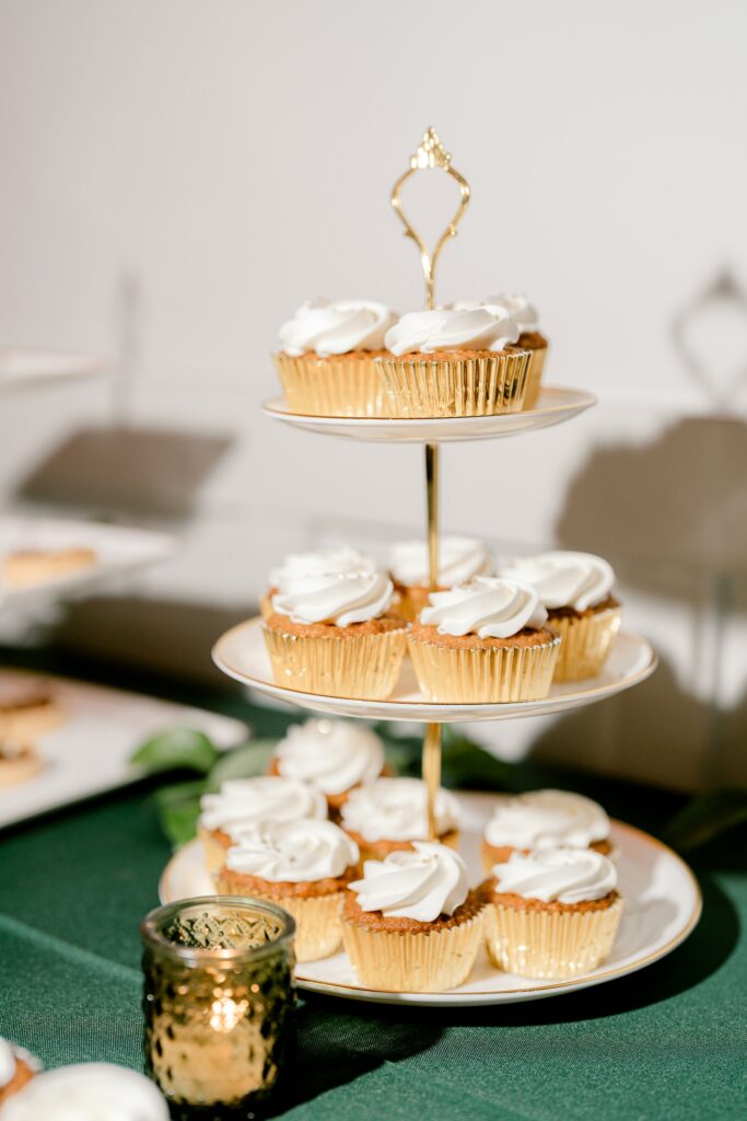 Frosted cupcakes on a gold tiered stand by Sweet Details GR