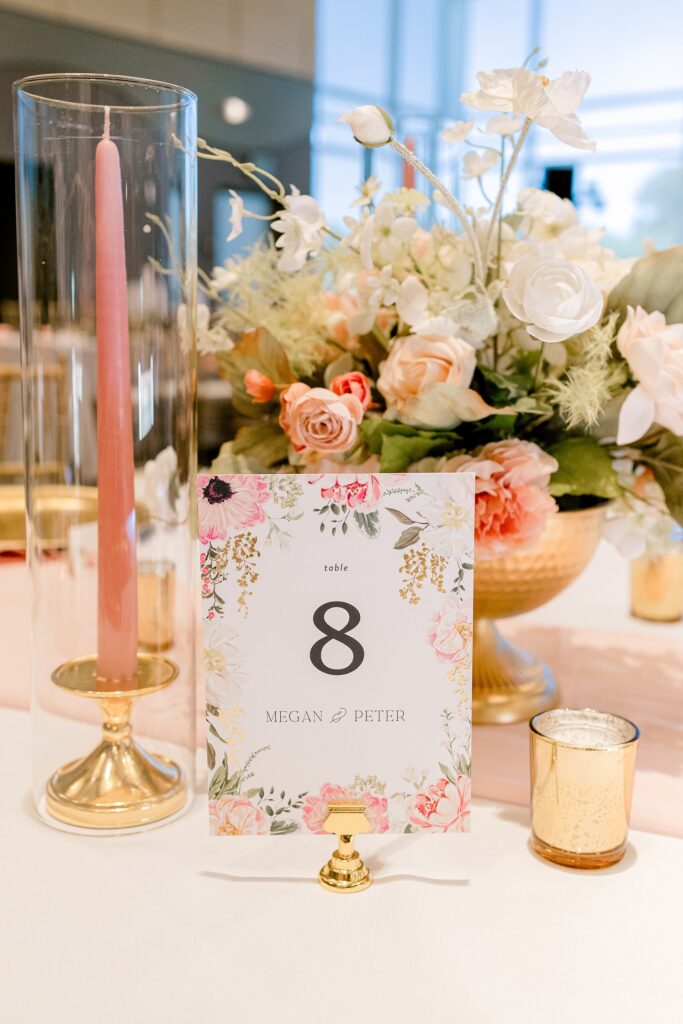 Floral table number with pink taper candles