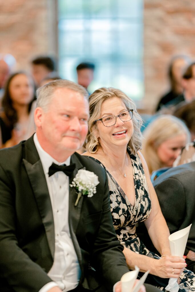 Wedding guests smiling during the ceremony