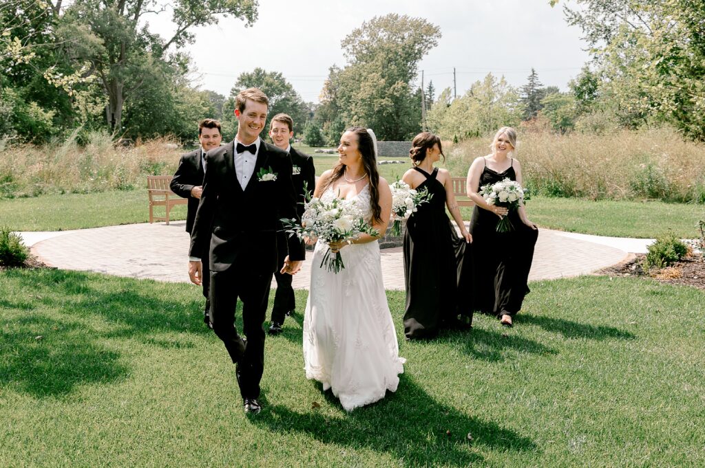 Wedding party walking across the lawn