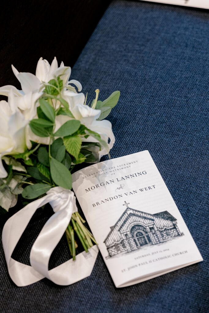 Wedding program and boutonniere on a church pew