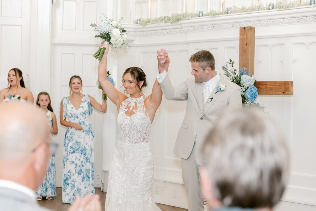 Bride and groom celebrating with their wedding party at the end of the ceremony
